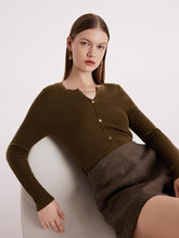 A lady wears a machine-washable wool V-neck sweater.